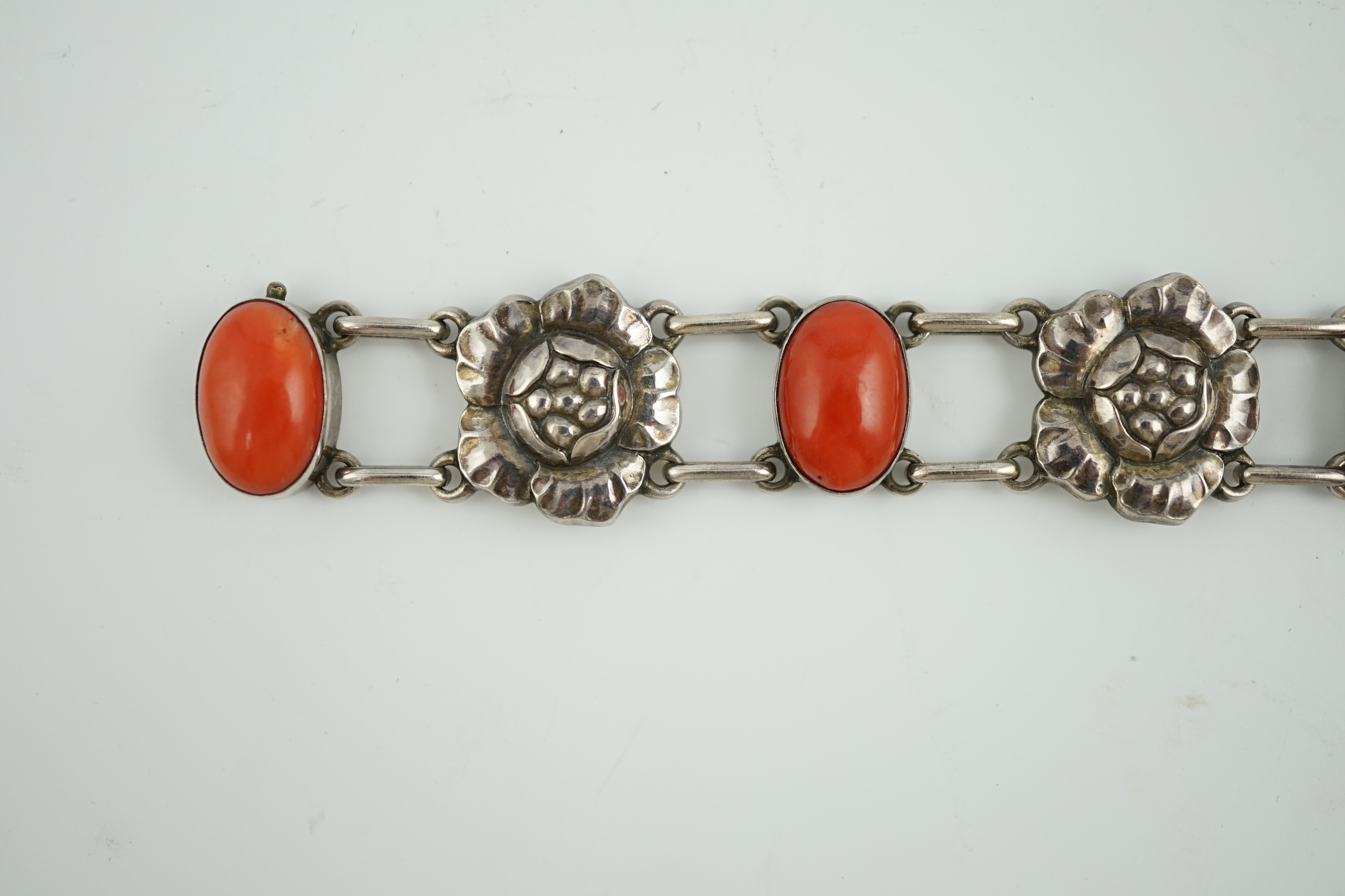 A George Jensen sterling silver and four stone cabochon coral set bracelet